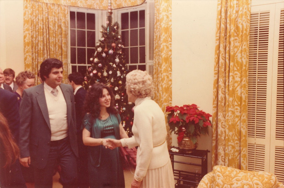 caption: Thelma Catherine "Pat" Nixon greets an unknown agent and his wife during a Christmas party at their apartment in New York City. This was after Nixon resigned from office.