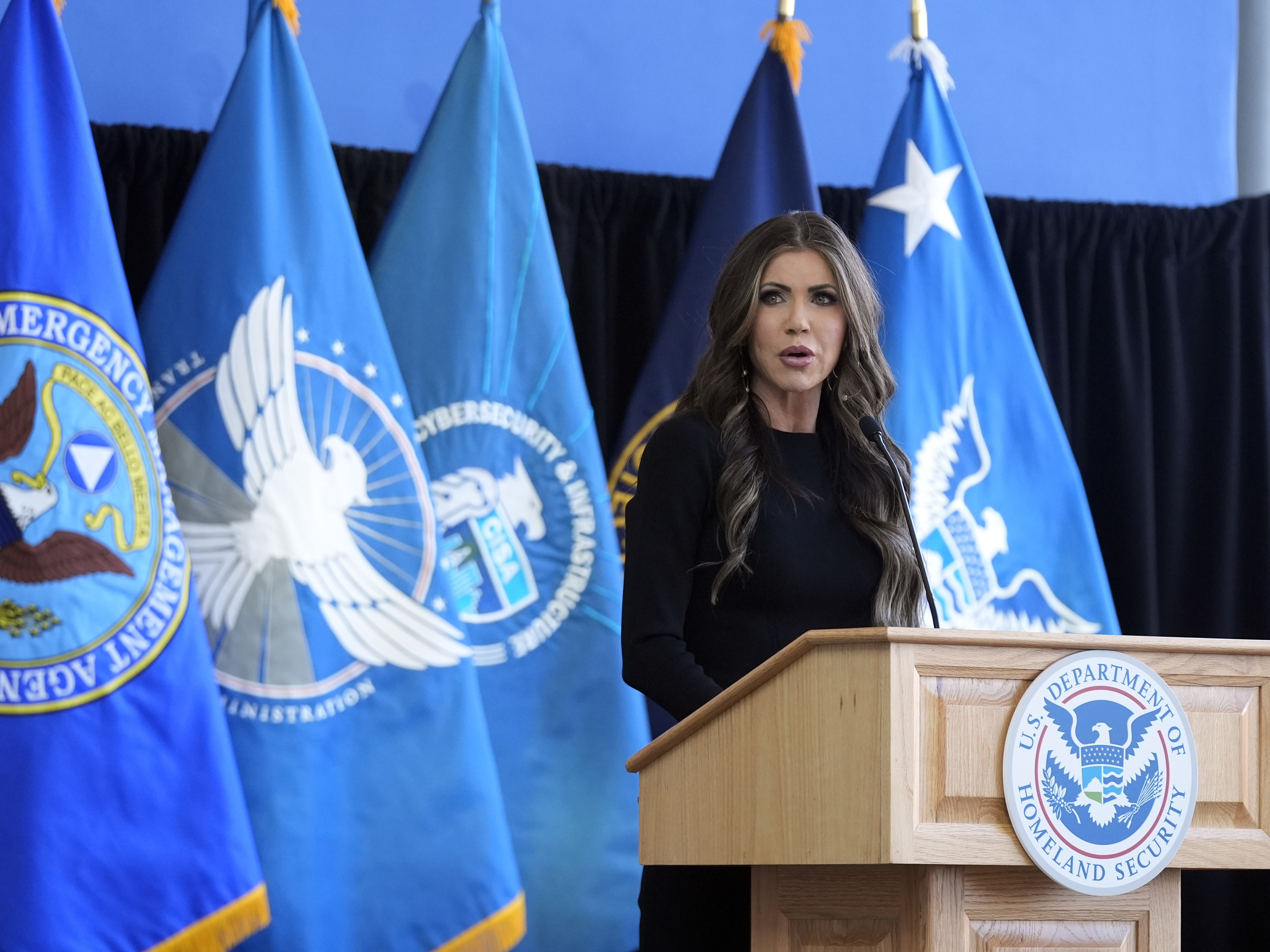 caption: U.S. Homeland Security Secretary Kristi Noem delivers remarks to staff at the Department of Homeland Security headquarters on Jan. 28, in Washington, DC.