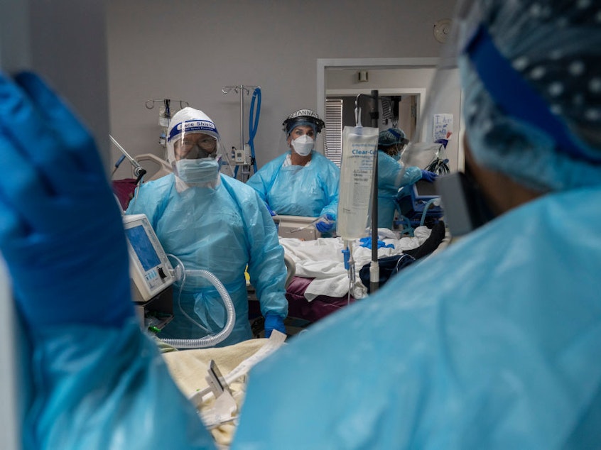 caption: Medical staff prepare for an intubation procedure on a patient suffering COVID-19 in an ICU in Houston, Texas. In some parts of the country, as hospitals get crowded, hospital leaders are worried they may need to implement crisis standards of care.