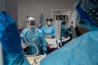 caption: Medical staff prepare for an intubation procedure on a patient suffering COVID-19 in an ICU in Houston, Texas. In some parts of the country, as hospitals get crowded, hospital leaders are worried they may need to implement crisis standards of care.