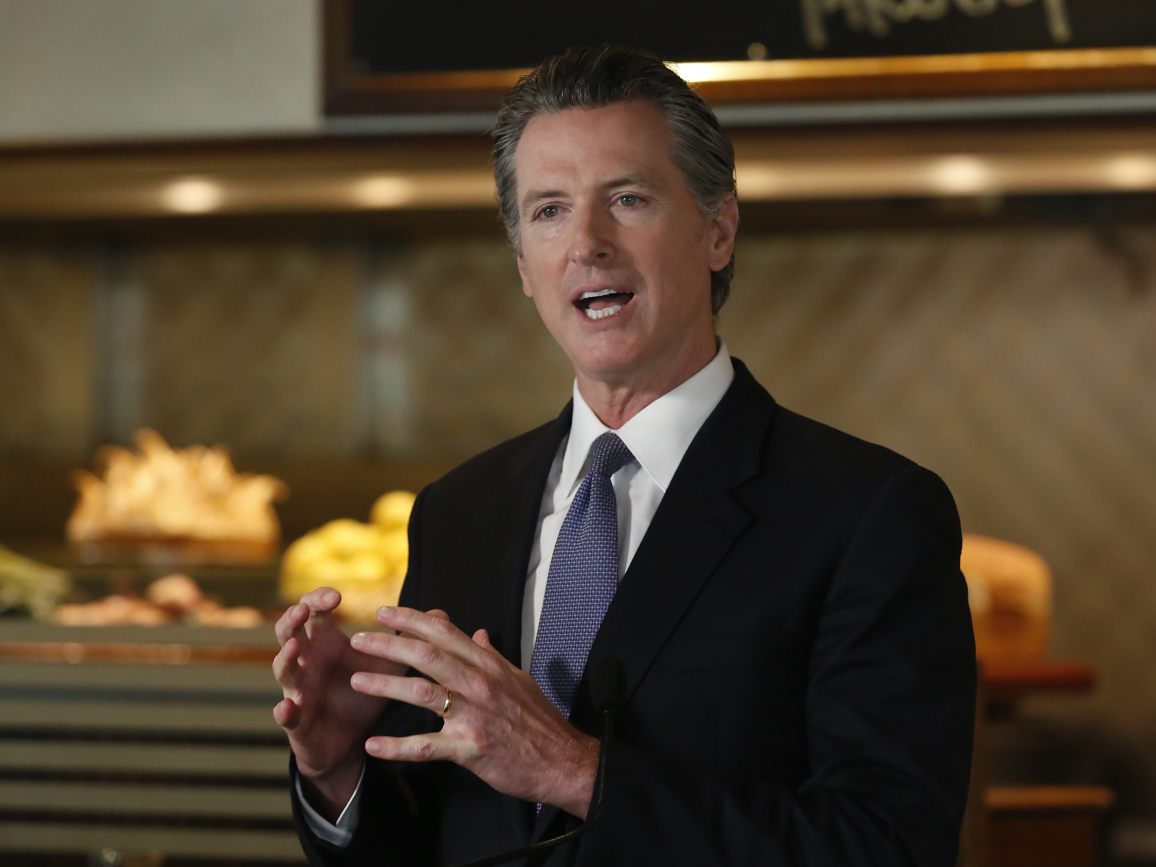 caption: Gov. Gavin Newsom announced new criteria related to coronavirus hospitalizations and testing that could allow counties to open faster than the state during a news conference in Napa, Calif., on Monday.