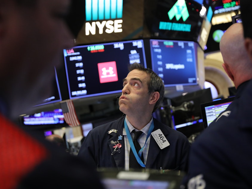 caption: With the Dow swinging up and down hundreds of points in a day, investors are feeling queasy. One economist says uncertainty in the stock markets may mean turbulence will continue in the new year.