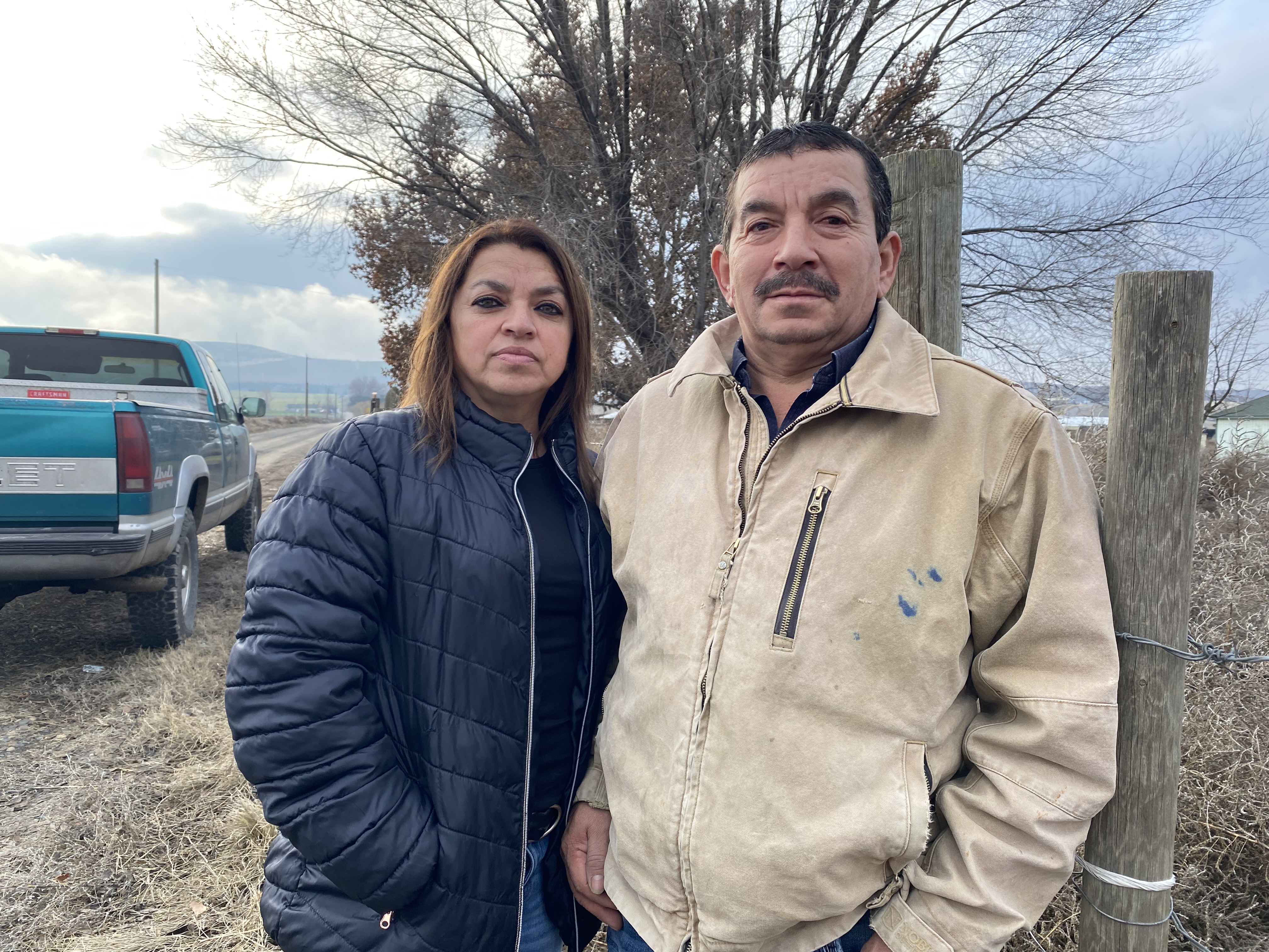 caption:  Sergio Madrigal and his wife, Rosa, stand outside the farm they owned, until recently, near Sunnyside, Washington. <br/>