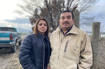 caption:  Sergio Madrigal and his wife, Rosa, stand outside the farm they owned, until recently, near Sunnyside, Washington. <br/>