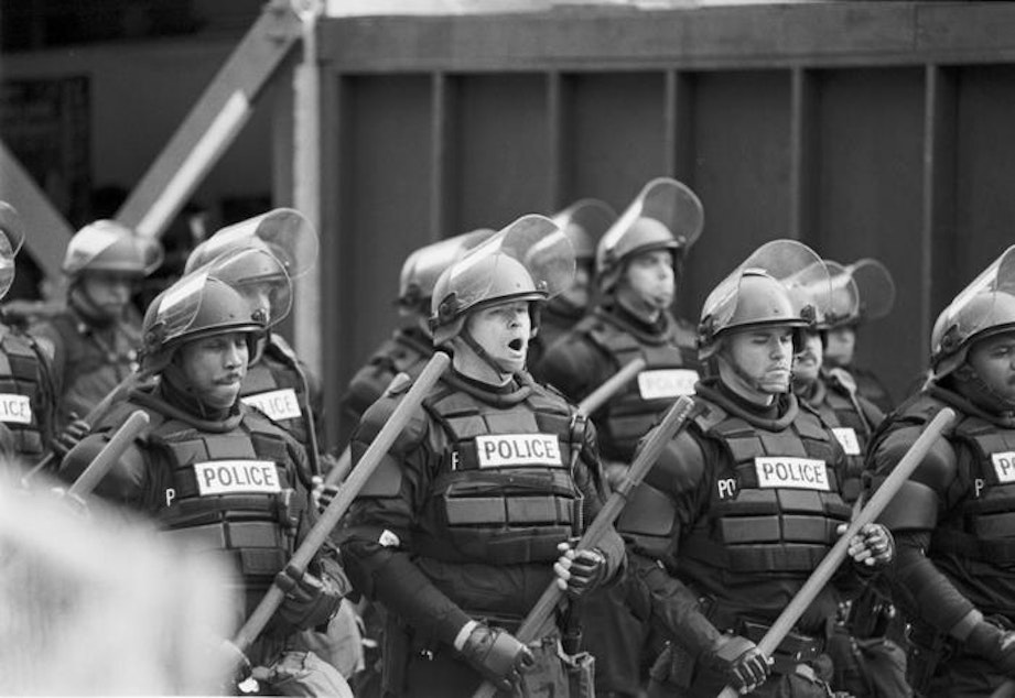 caption: Police used tear gas to clear the streets of protesters during the WTO convention in Seattle on Nov. 29, 1999. 