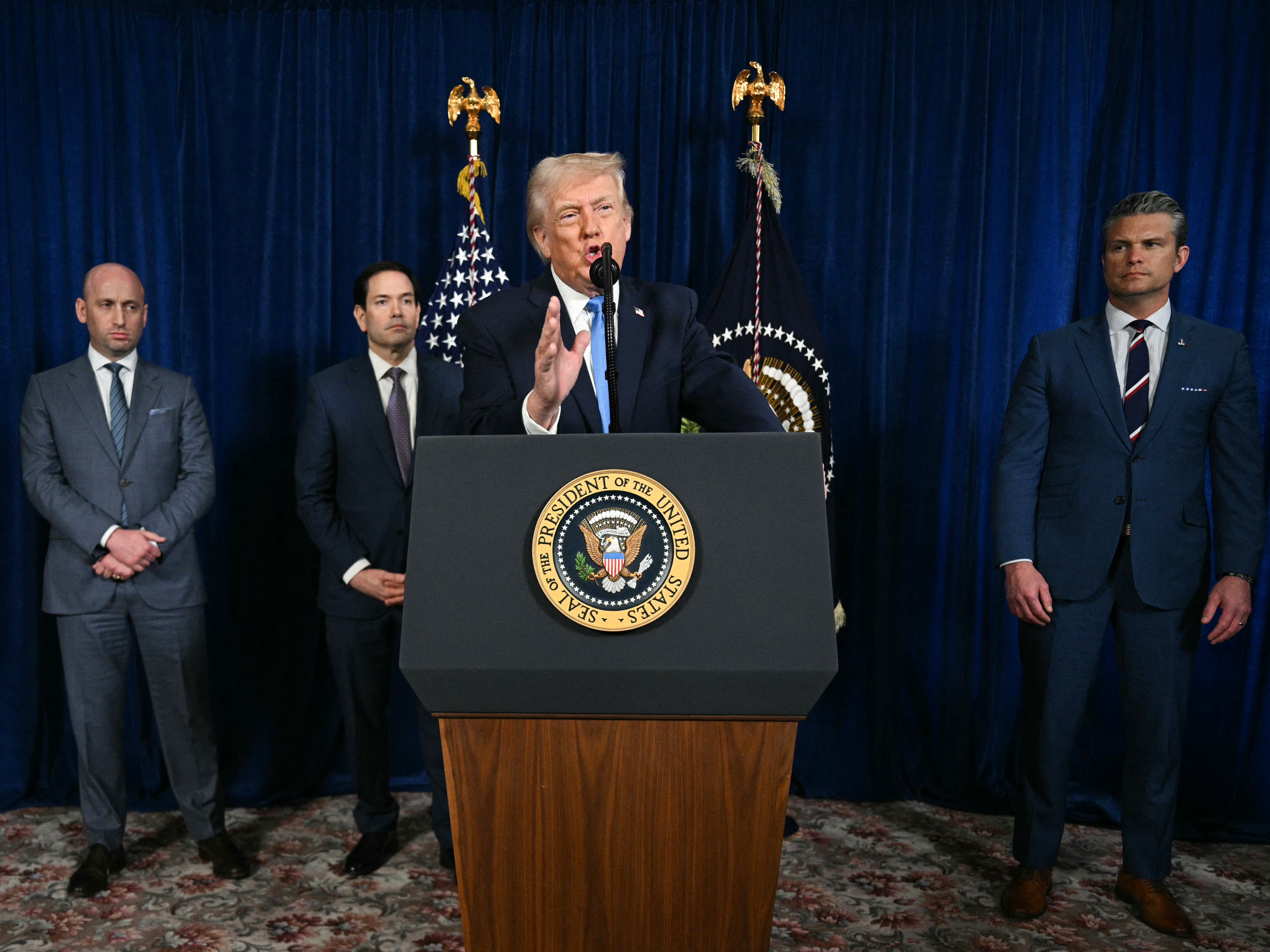 caption: President Donald Trump, alongside (L/R) Deputy Chief of Staff Stephen Miller, Secretary of State Marco Rubio, and US Secretary of Defense Pete Hegseth, speaks to the media following US military actions in Venezuela, at his Mar-a-Lago residence in Palm Beach, Florida, on Jan. 3.
