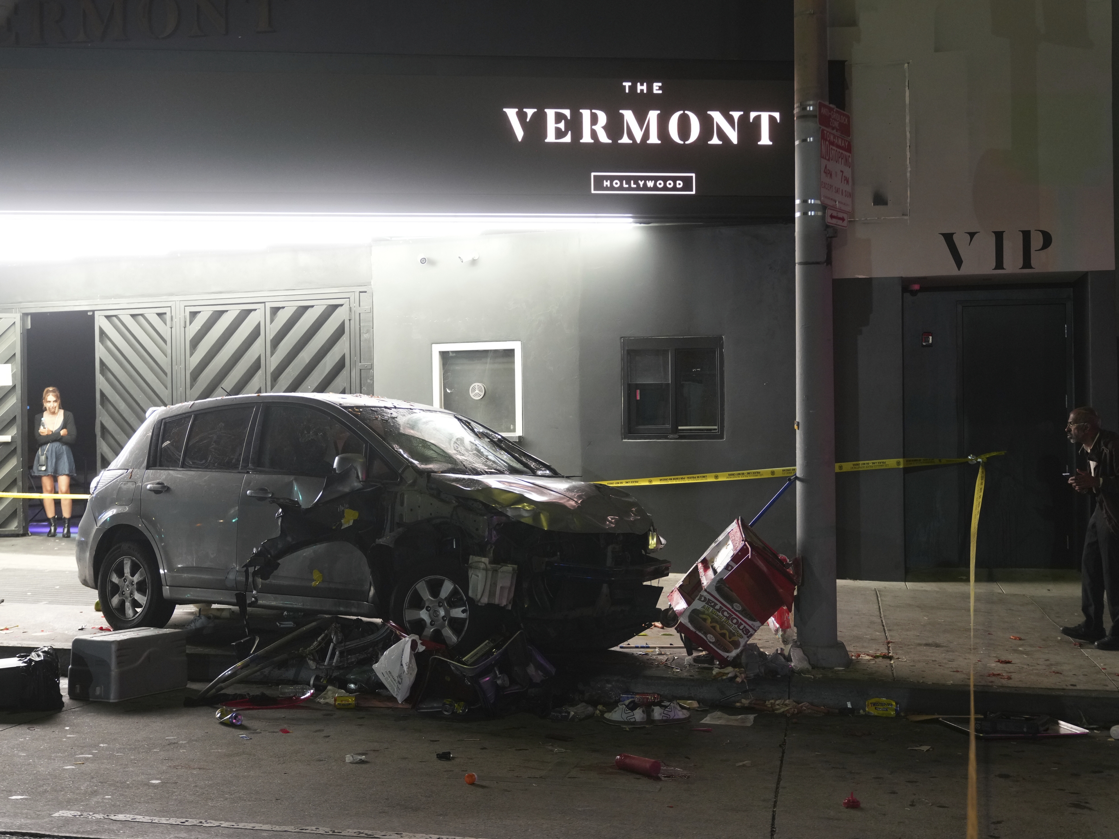 caption: A vehicle sits on the sidewalk after ramming into a crowd of people waiting to enter a nightclub along a busy boulevard in Los Angeles early Saturday, July 19, 2025 injuring several people.