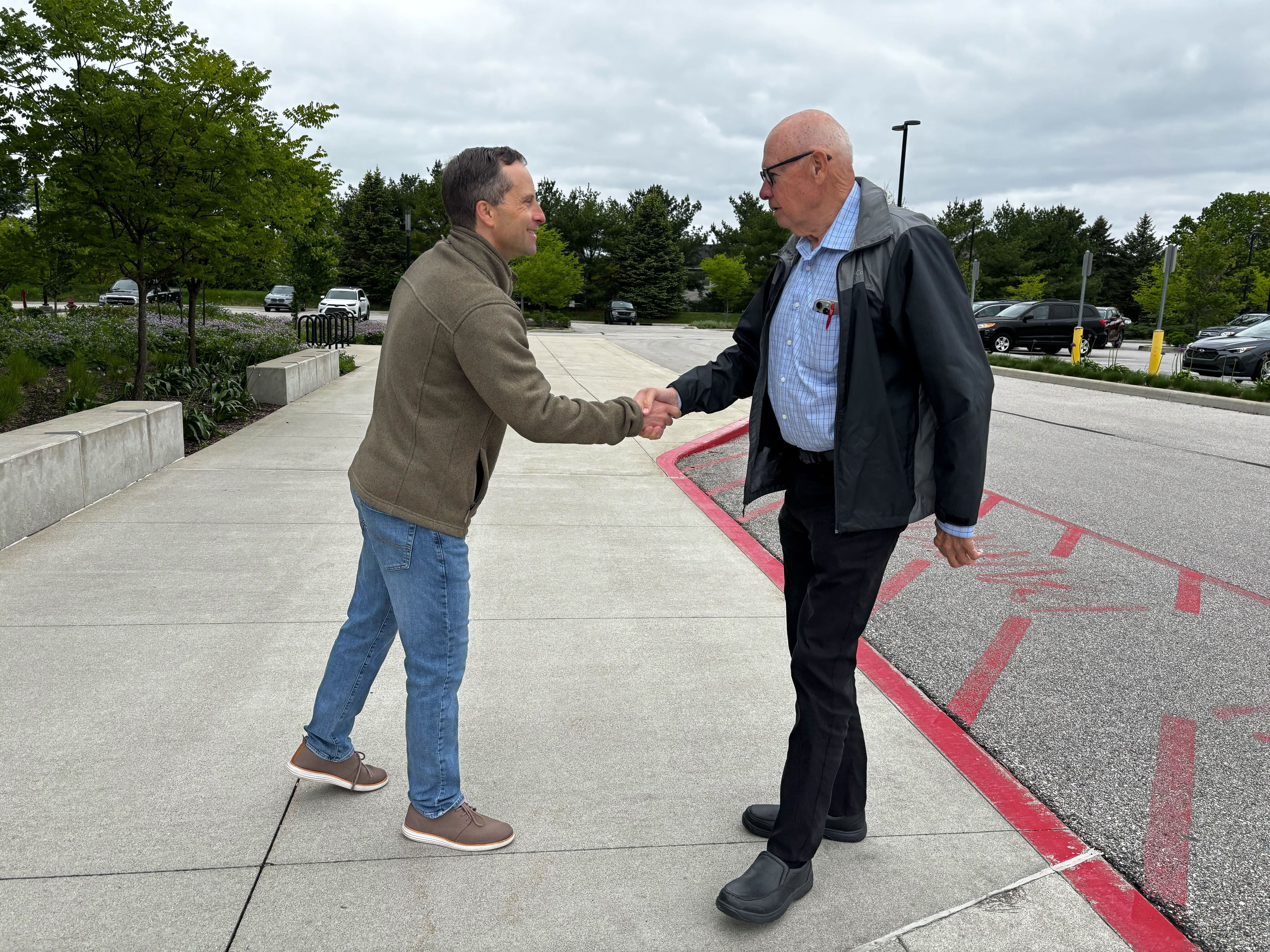 caption: Outside a polling place in West Lafayette, Ind., Republican state Sen. Spencer Deery greets voters arriving for early voting on April 28. Deery is a Republican incumbent President Trump has targeted after he opposed the president's redistricting push in Indiana.
