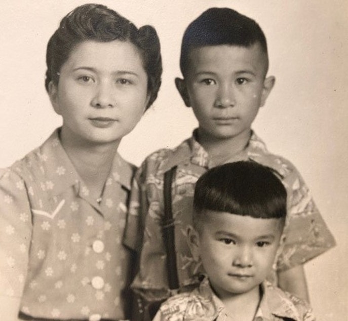 caption: Kenji Ima along with his mother Mary and his older brother Paul, in a photo taken during their wartime confinement in Minidoka. 