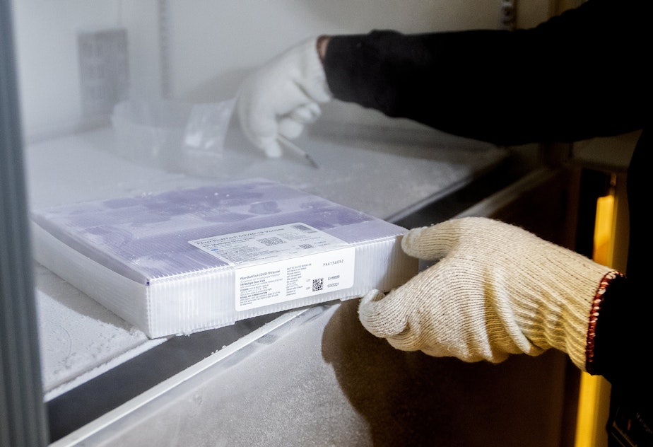 caption: University of Washington Medical Center Pharmacy Manager Christine Meyer puts a tray of doses of the Pfizer-BioNTech COVID-19 vaccine into the deep freeze after the vaccine arrived at the University of Washington Medical Center's Montlake campus Monday, Dec. 14, 2020, in Seattle.