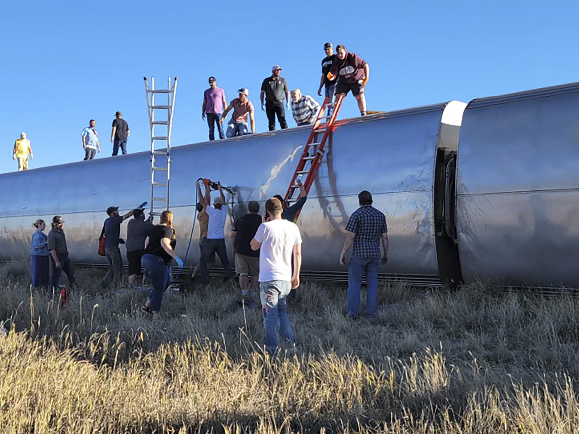 caption: In this photo provided by Kimberly Fossen, people work at the scene of an Amtrak train derailment on Saturday in north-central Montana. Multiple people were injured when the train that runs between Seattle and Chicago derailed Saturday, the train agency said.