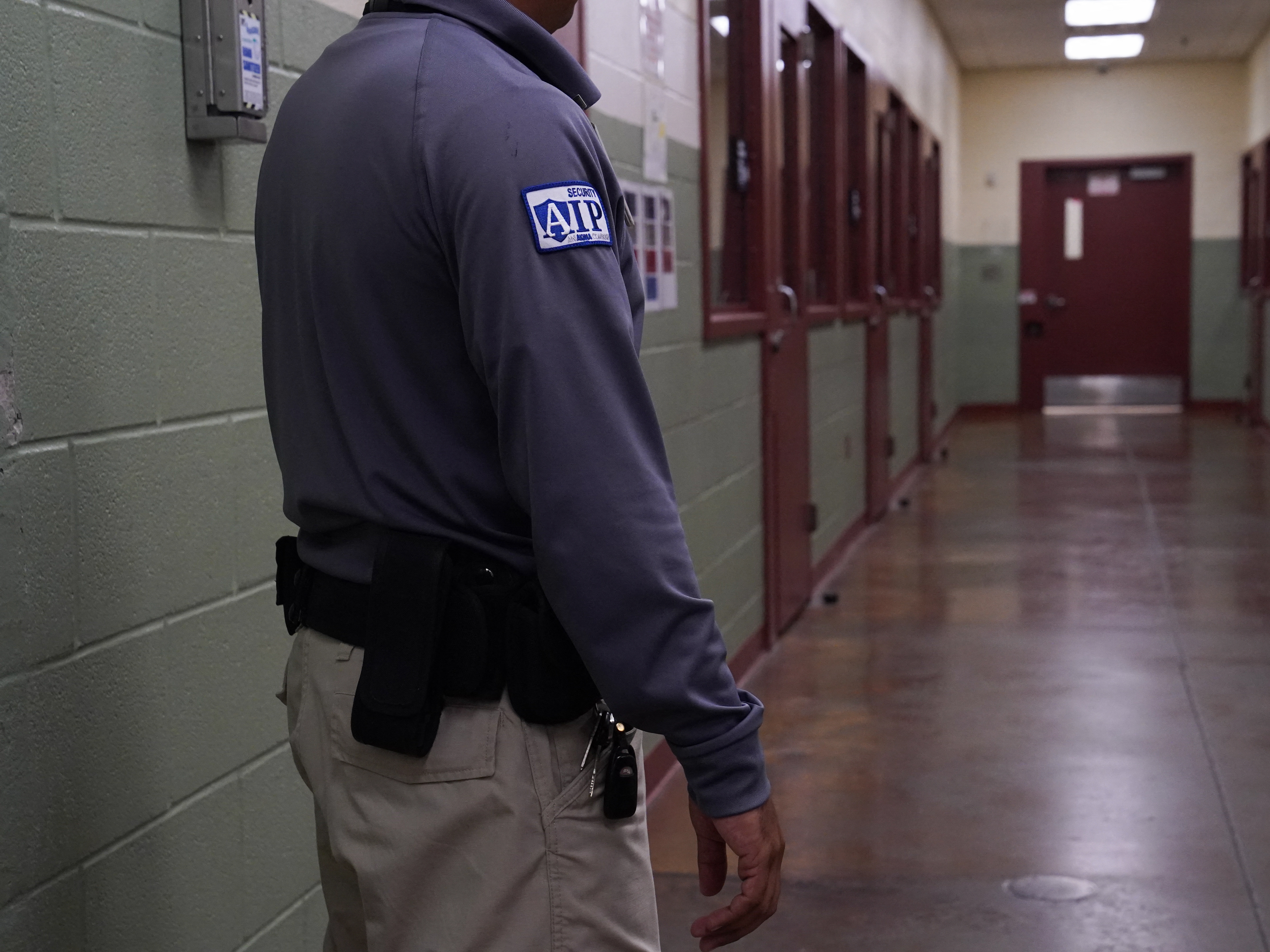 caption: A security guard poses during a media tour of the Port Isabel Detention Center hosted by ICE in Los Fresnos, Texas in 2024. The Trump administration seeks to reopen family detention centers in the state.