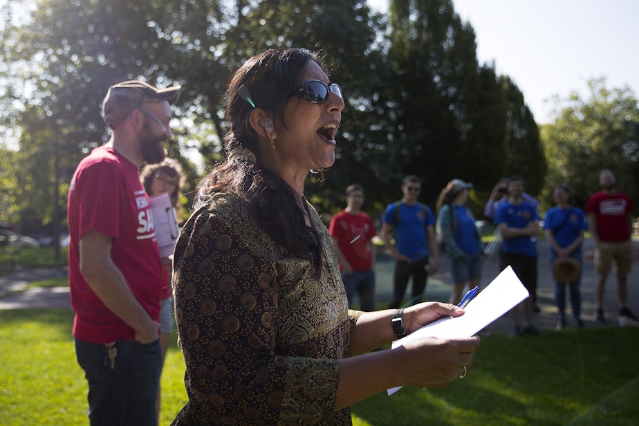 caption: Councilmember Kshama Sawant talks to a group of union members before they go door knocking on Sunday, August 4, 2019, at Pratt Park in Seattle. 
