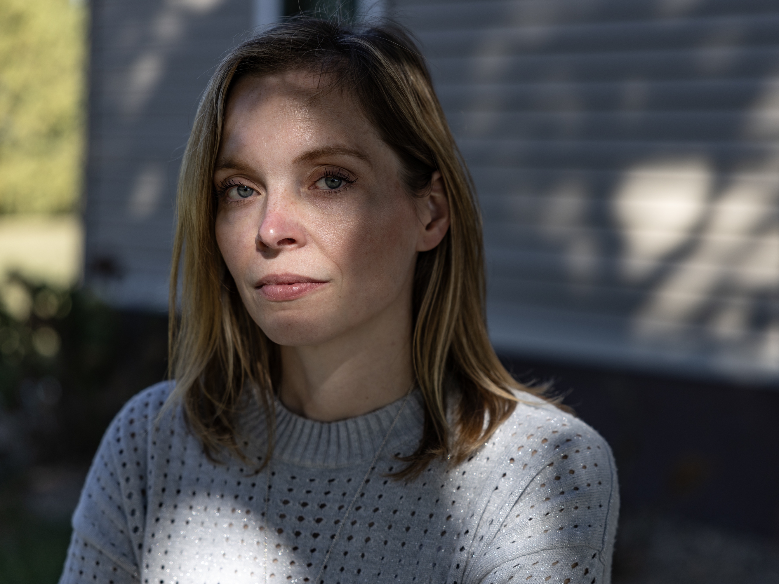 caption: Dr. Emily Boevers, an OBGYN based in Waverly, Iowa, poses for a portrait at her family's farm in nearby Tripoli. She says the state's rape exception requirements threaten the privacy, trust and intimacy of the patient-doctor relationship.