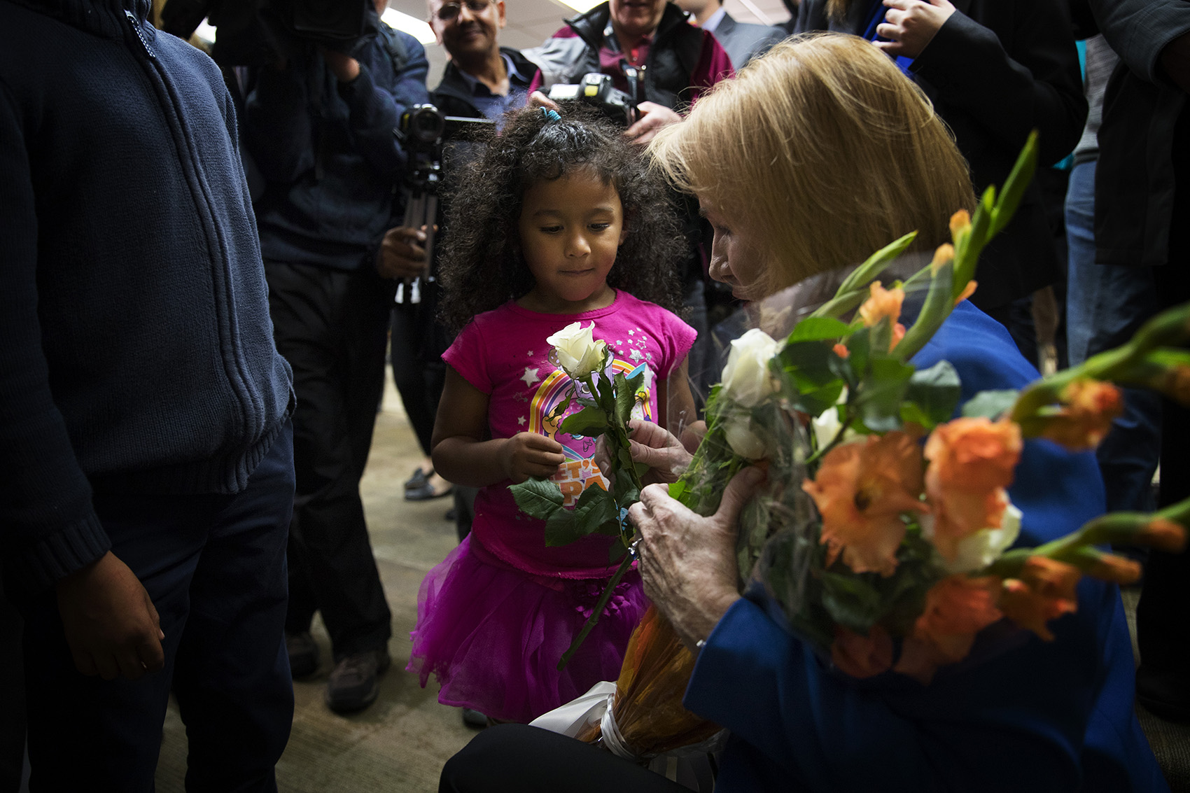 caption:  Seattle mayor Jenny Durkan gives a rose to 4-year-old Araceli Cotto, after taking the oath of office on Tuesday, November 28, 2017, at the Ethiopian Community Center in Seattle. 