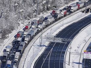 caption: Cars and trucks are stranded on sections of Interstate 95 Tuesday Jan. 4, 2022, near Quantico, Va. Close to 48 miles of the Interstate was closed due to ice and snow.