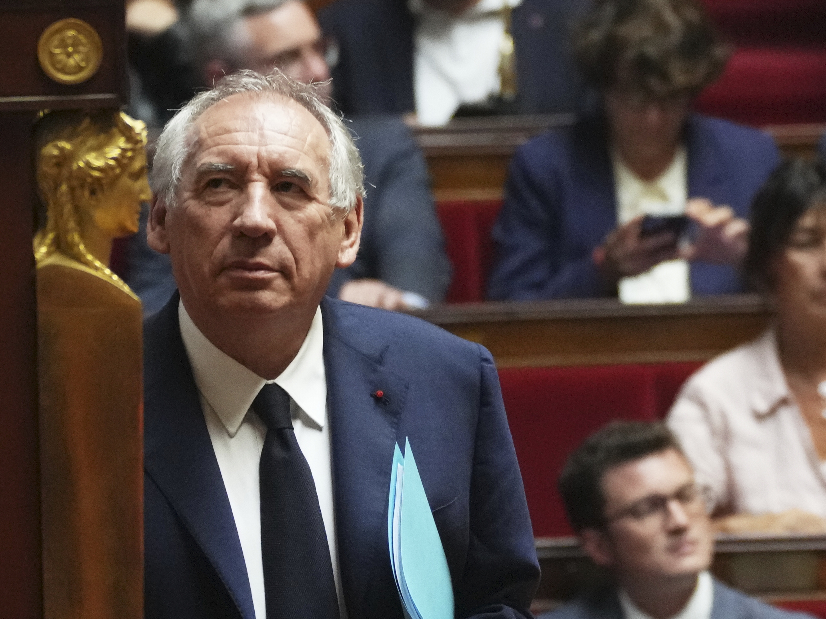 caption: French Prime Minister Francois Bayrou arrives to address the National Assembly, prior to the parliamentary confidence vote, in Paris, France, Monday, Sept. 8.