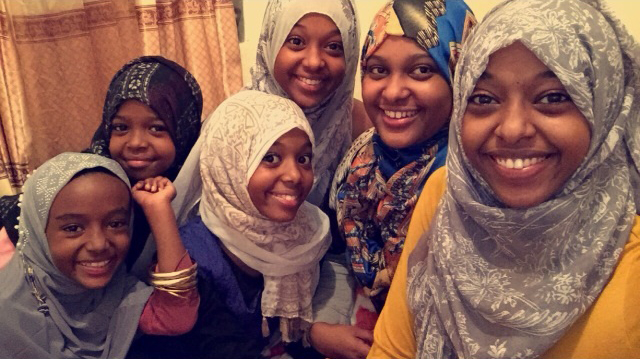 caption: Amane Robale (second from right) is surrounded by five of her younger siblings. There are 10 children in the family in all.