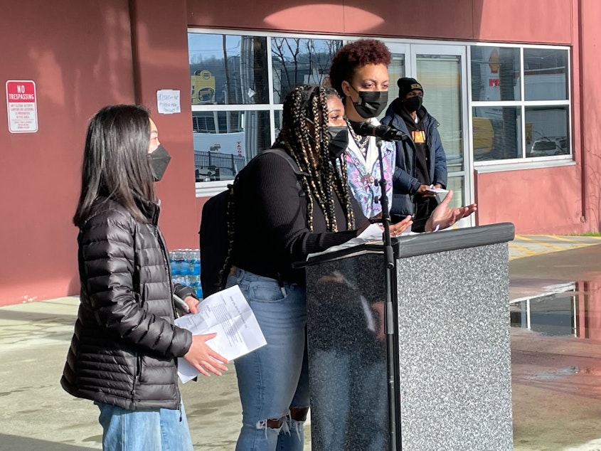 caption: Nya Spivey of Cleveland High School addresses the crowd outside the John Stanford Center for Educational Excellence.