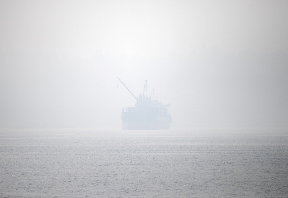 caption: A ship heads toward Seattle as a massive plume of smoke from wildfires burning in California and Oregon clouds the sky on Friday, September 11, 2020, in Seattle. 