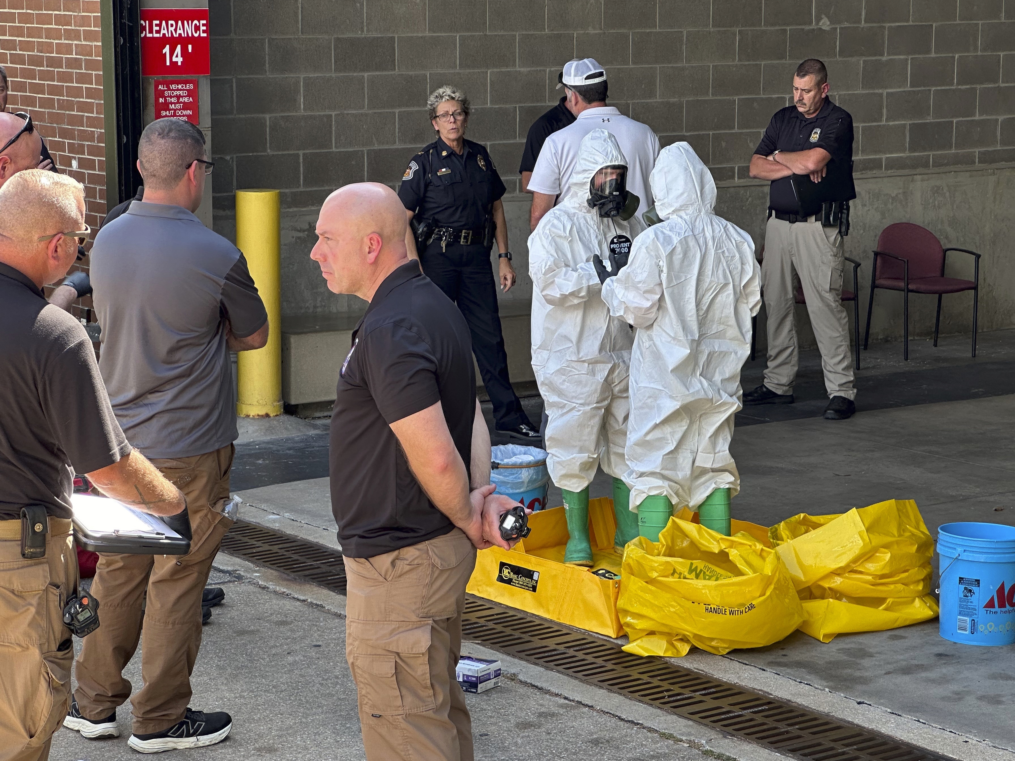 caption: A hazmat crew from the National Guard's Civilian Support Team investigates after a suspicious package was delivered to election officials at the Missouri secretary of state's Jefferson City, Mo., office on Tuesday.