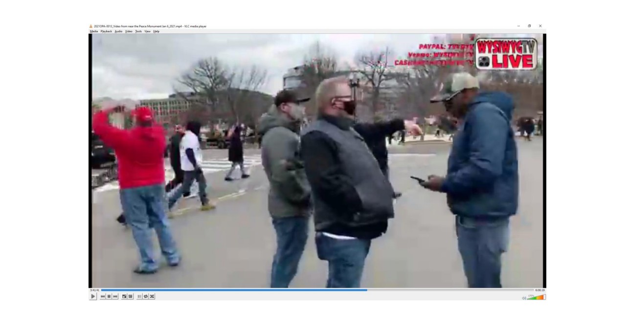 caption: Investigators said this video still shows SPD Detective Michael Settle, left, Sgt. Jacob Briskey, middle, and former SPD officer Adley Shepherd, right, near the Peace Monument in Washington, D.C. on Jan. 6, 2021. 