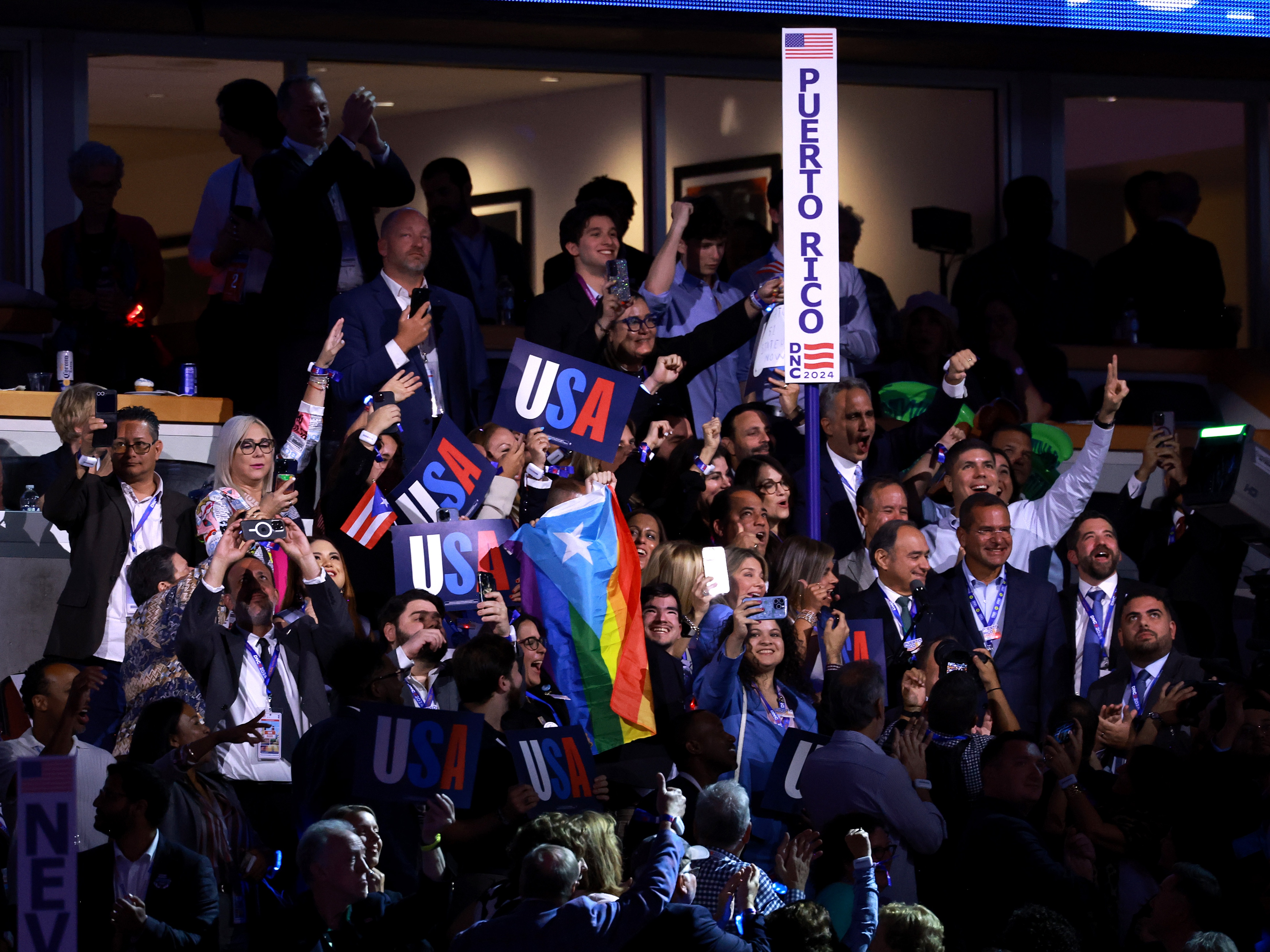 caption: Members of the Puerto Rico delegation cast their votes during the roll call.