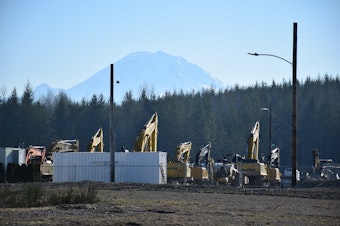caption: Mount Rainier looms behind the site of the Oakpointe development in Black Diamond, Washington.