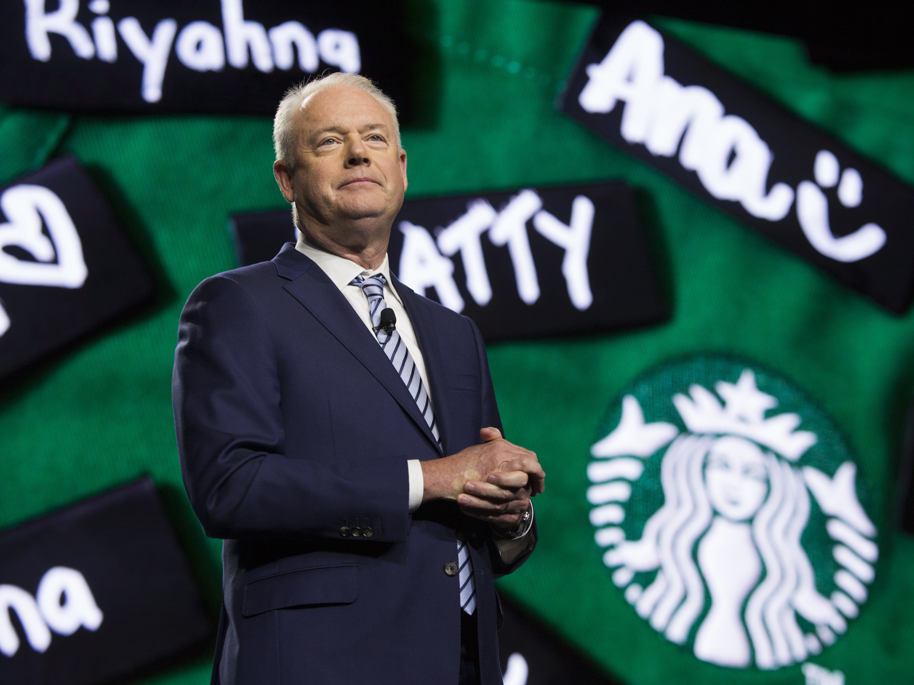 caption: Starbucks President and Chief Executive Officer Kevin Johnson speaks at the Annual Meeting of Shareholders in Seattle, Washington on March 20, 2019. The company announced his departure just hours before the 2022 shareholders meeting.
