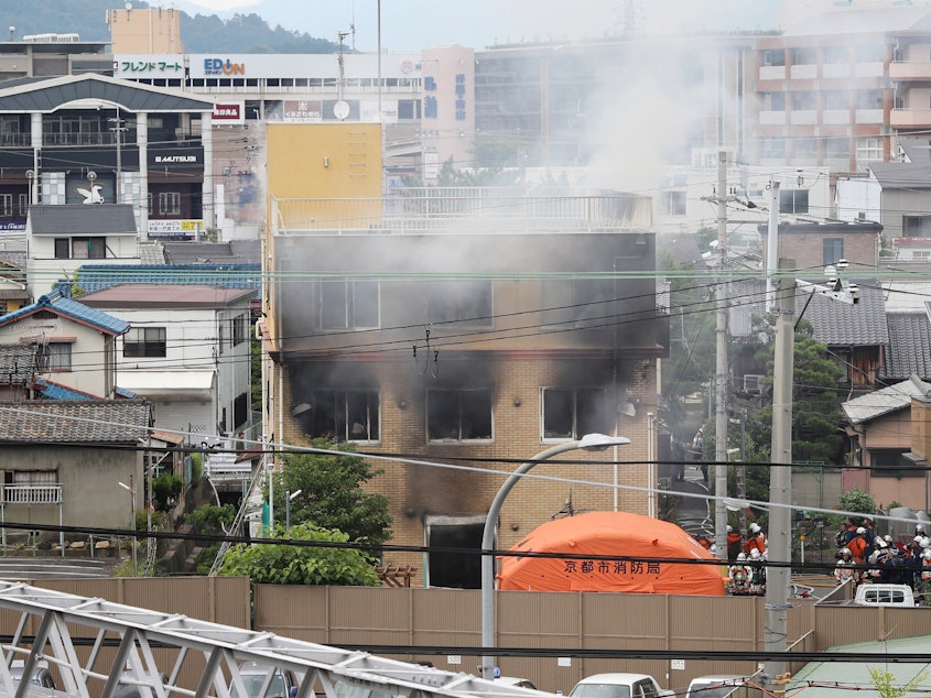 caption: Smoke rises from an animation company building after a fire in Kyoto, Japan, on Thursday.