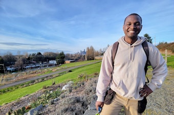 caption: Beacon Food Forest Site and Programs Director Khalil Griffith stands in the gardens on Friday, February 9, 2024.