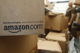 caption: FILE - In this Oct. 18, 2010 file photo, an Amazon.com package awaits delivery from UPS in Palo Alto, Calif.