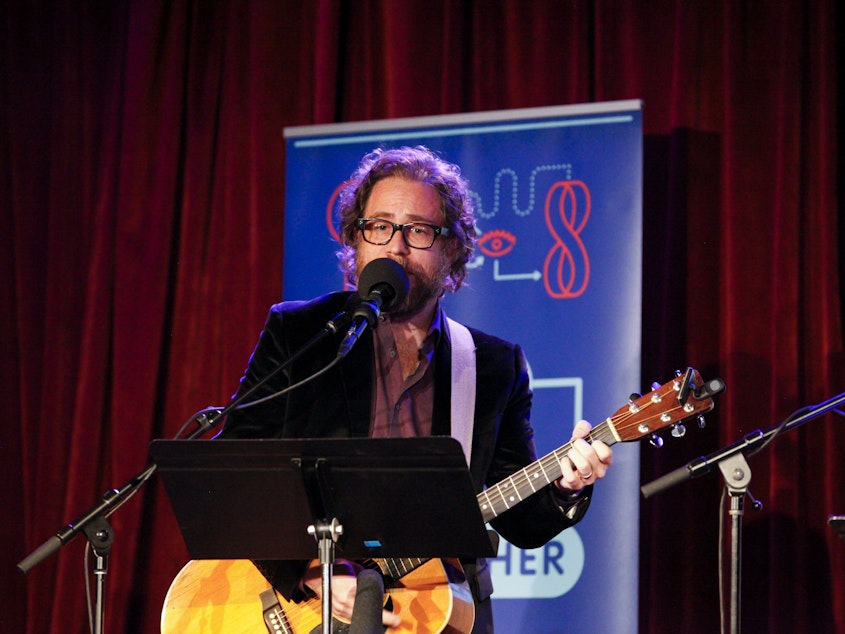 caption: <em>Ask Me Another</em>'s house musician Jonathan Coulton leads a music parody game at the Bell House in Brooklyn, New York.