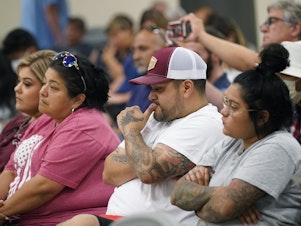 caption: Family of shooting victims listen to the Texas House investigative committee release its full report on the shootings at Robb Elementary School, Sunday, July 17, 2022, in Uvalde, Texas.