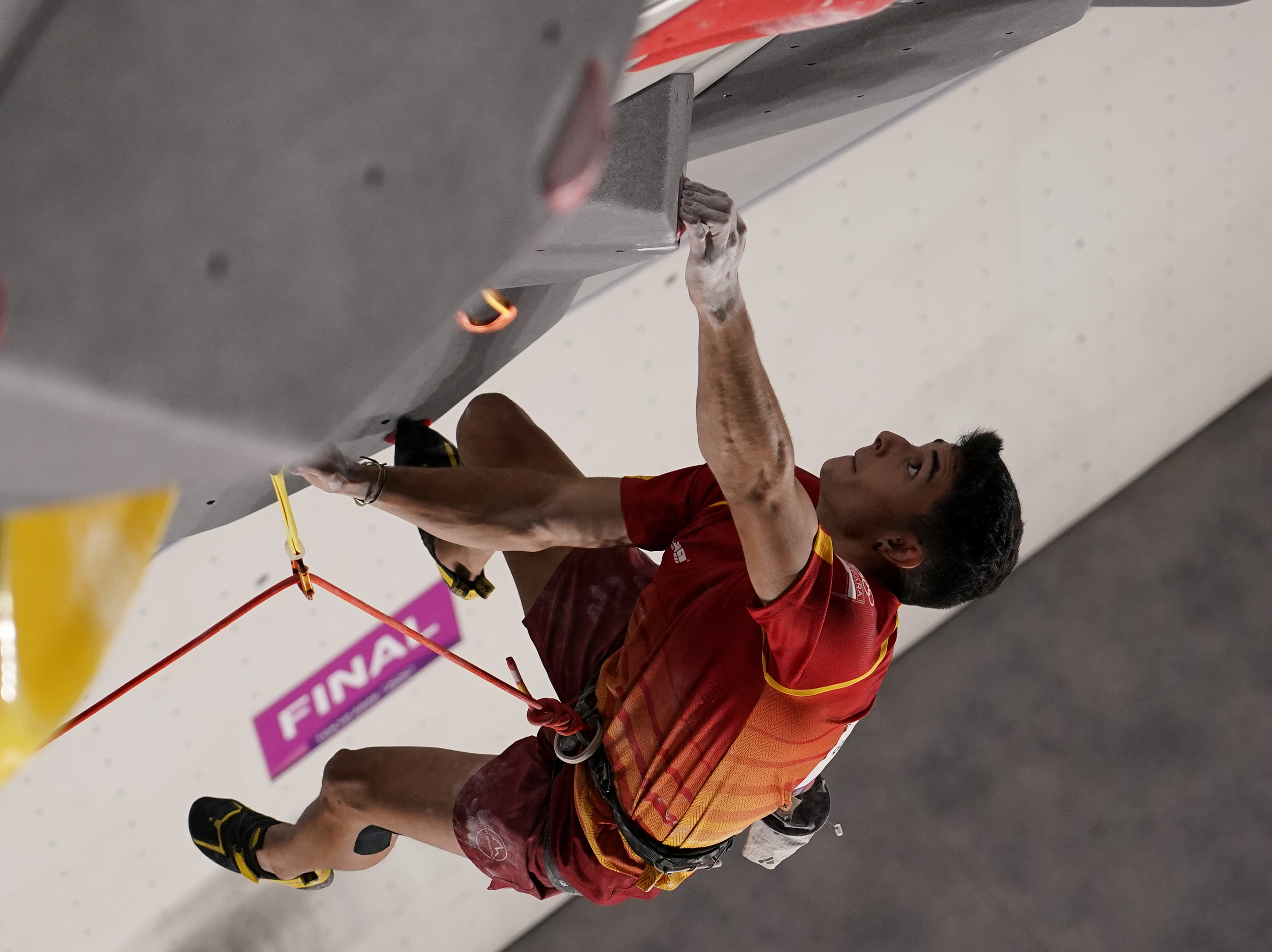 caption: Spain's Alberto Ginés López climbs during the Sport Climbing men's combined final of the Tokyo Olympic Games.