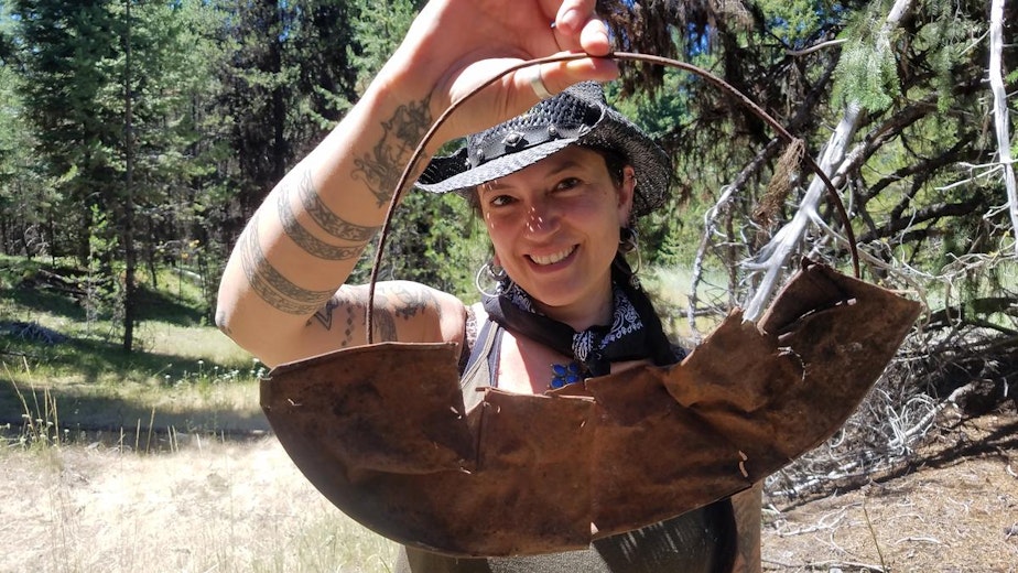 caption: Southern Oregon University archaeologist Chelsea Rose with remnants of a five-part gold pan found during a dig this summer.CREDIT SOUTHERN OREGON UNIV. LABORATORY OF ANTHROPOLOGY