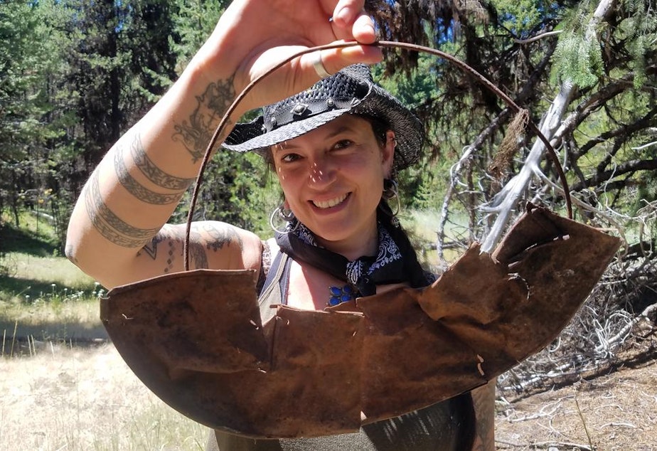 caption: Southern Oregon University archaeologist Chelsea Rose with remnants of a five-part gold pan found during a dig this summer.CREDIT SOUTHERN OREGON UNIV. LABORATORY OF ANTHROPOLOGY