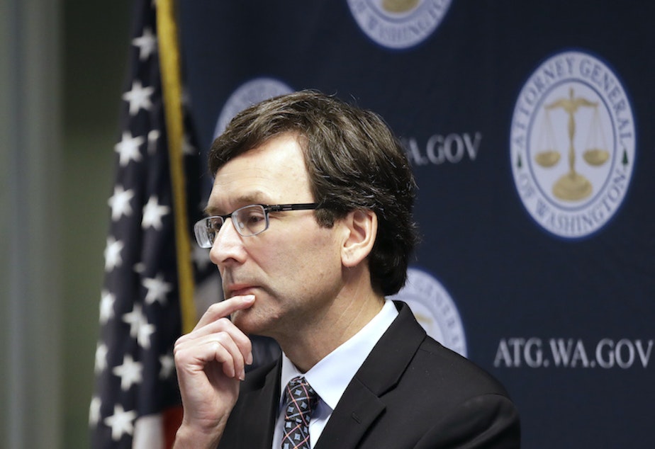 caption: Washington state Attorney General Bob Ferguson looks on during a news conference in Seattle on Dec. 17, 2019.