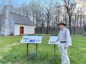 caption: Matt Reeves, a former employee of Montpelier who was fired this week, pictured outside of the historic Gilmore cabin at Montpelier.