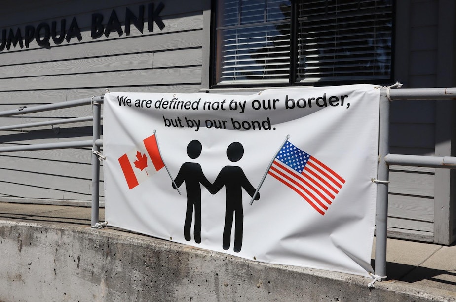 caption: A common sign hanging outside businesses in Point Roberts that yearn to have Canadian visitors back.