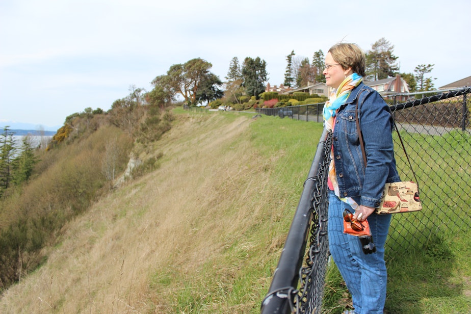caption: Ruth Trail, a resident of the Magnolia area of Seattle, surveys where a landslide took out homes on Perkins Lane in 1996.