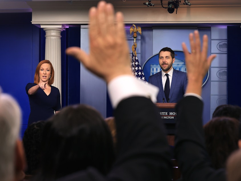 caption: White House press secretary Jen Psaki and Brian Deese, director of the National Economic Council, take questions from reporters on Friday.