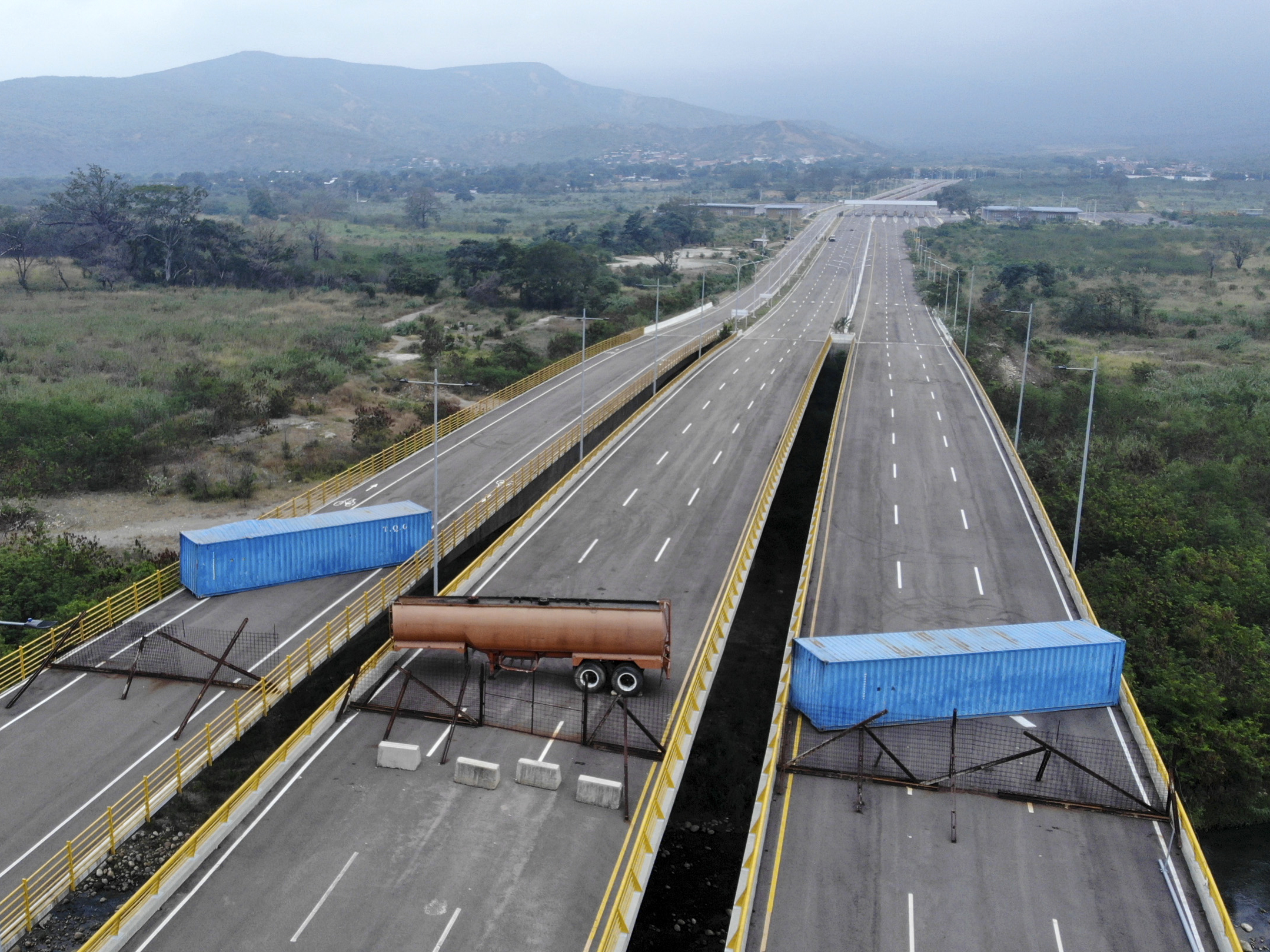 caption: The Tienditas bridge connecting Colombia and Venezuela has been blocked by Venezuelan military forces, as seen here on Wednesday. Opposition leader Juan Guaidó and U.S. Secretary of State Mike Pompeo are demanding that humanitarian aid be allowed to enter.