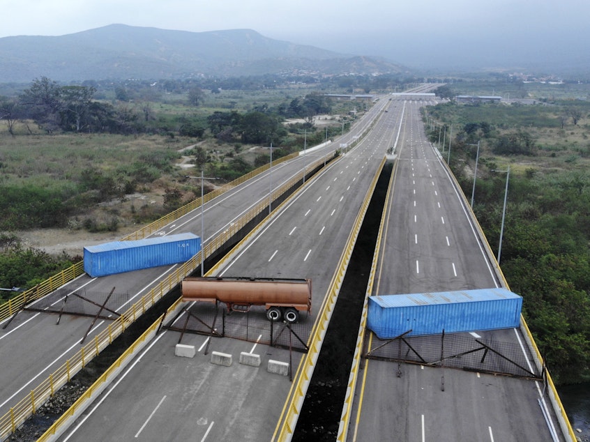 caption: The Tienditas bridge connecting Colombia and Venezuela has been blocked by Venezuelan military forces, as seen here on Wednesday. Opposition leader Juan Guaidó and U.S. Secretary of State Mike Pompeo are demanding that humanitarian aid be allowed to enter.