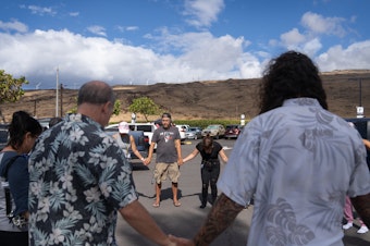 caption: A group of volunteers with Maui Medic Healers Hui gather before heading out to help people affected by the fires in Lahaina.