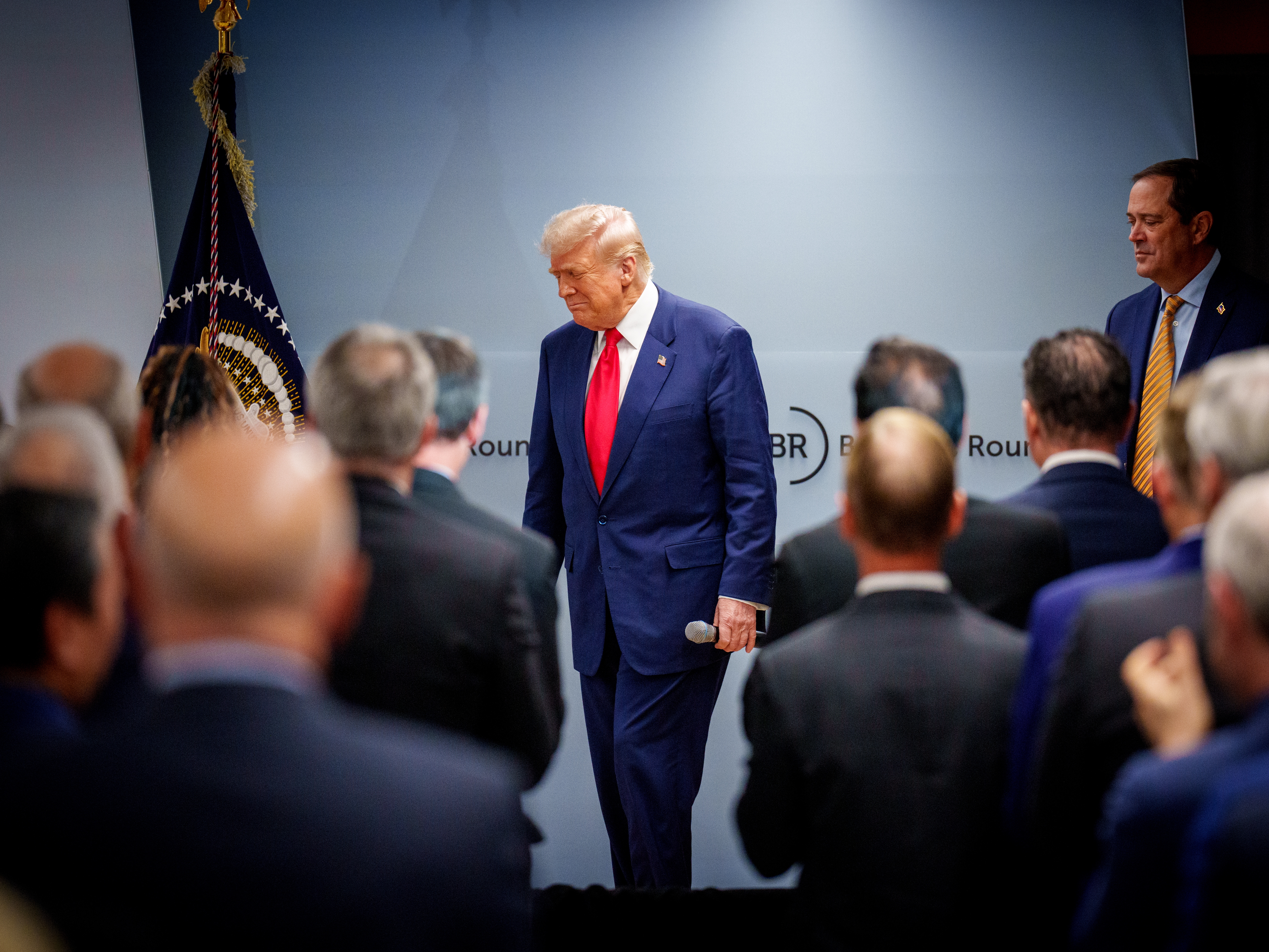 caption: President Trump arrives at the Business Roundtable's quarterly meeting on March 11, to address a group of CEOs amid an ongoing market selloff sparked by his new tariffs.