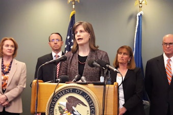 caption: Amy Wales, daughter of Thomas Wales speaks at a news conference on February 21, 2018 in Seattle. At left is Mayor Jenny Durkan, and deputy U.S. Attorney General Rod Rosenstein. Rosenstein was in Seattle to give an update on the Wales case.