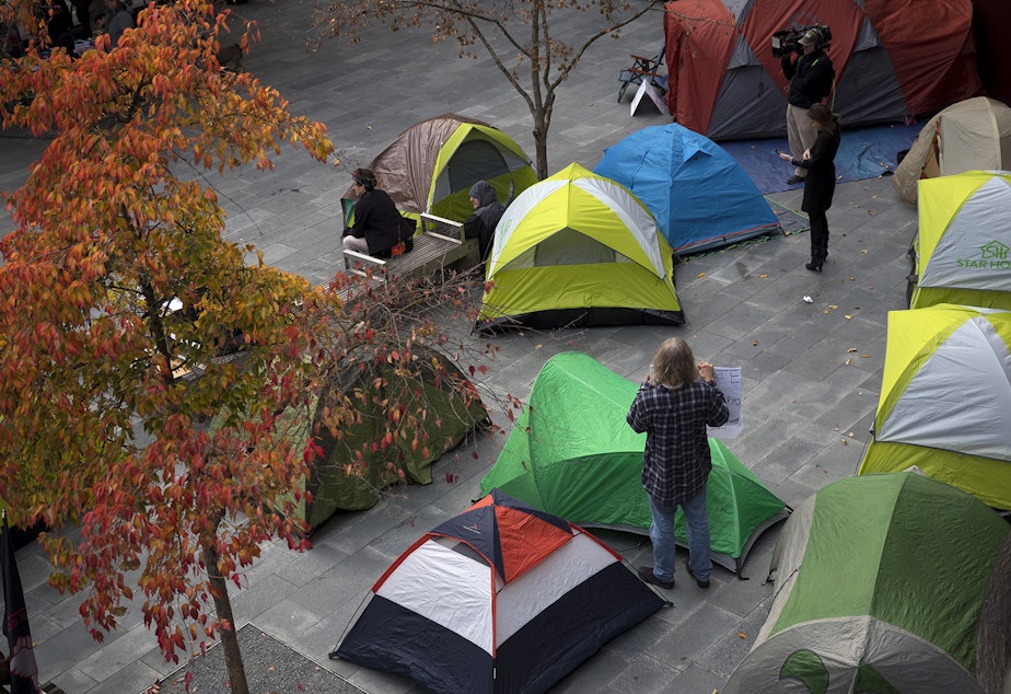 caption: Tents are shown as people gathered to protest the sweeps of homeless camps in November, 2017, at City Hall in Seattle.