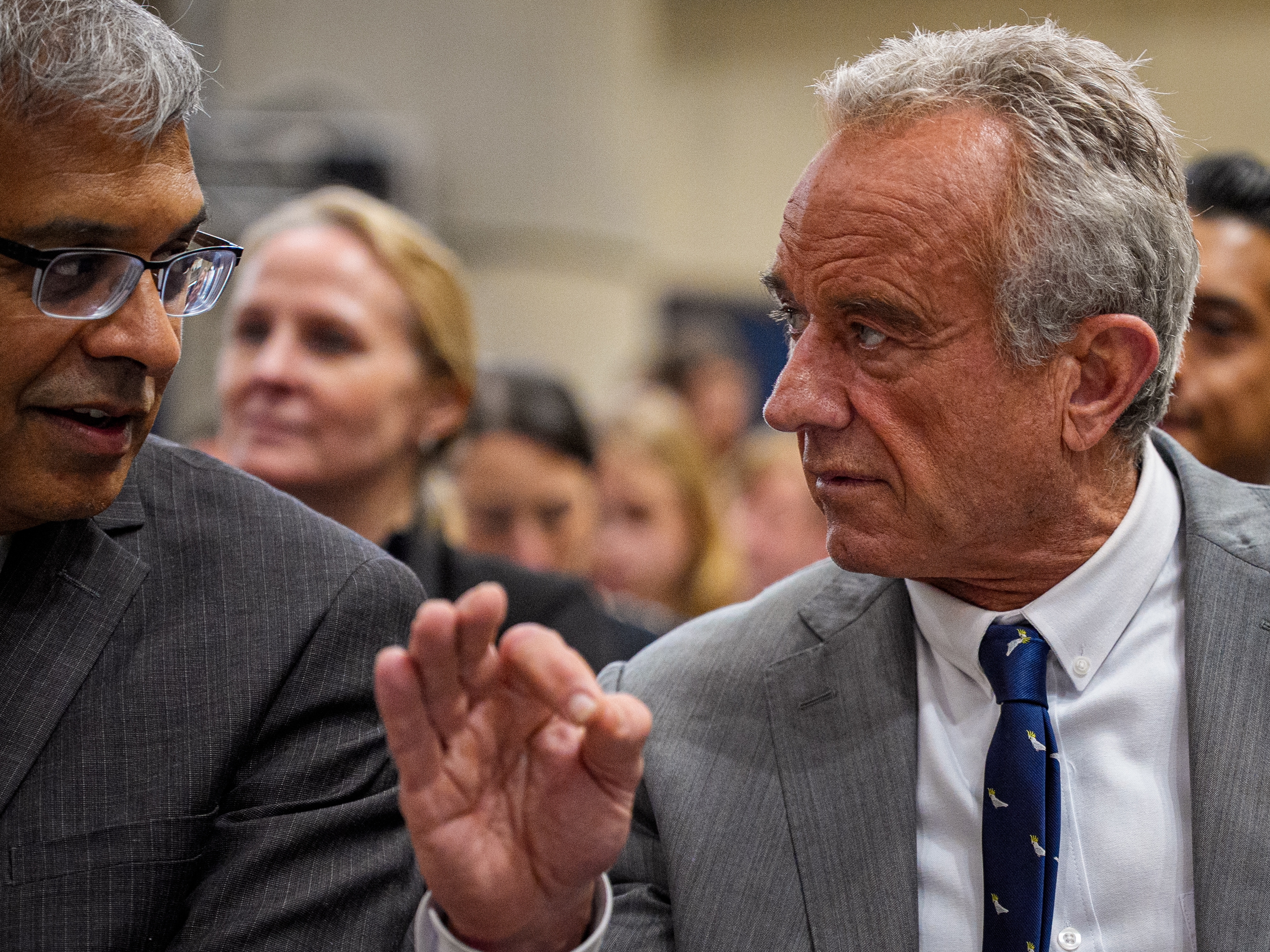 caption: NIH Director Jayanta Bhattacharya, left, and Health and Human Services Secretary Robert F. Kennedy Jr. speak before a news conference at the Health and Human Services Department on April 22.