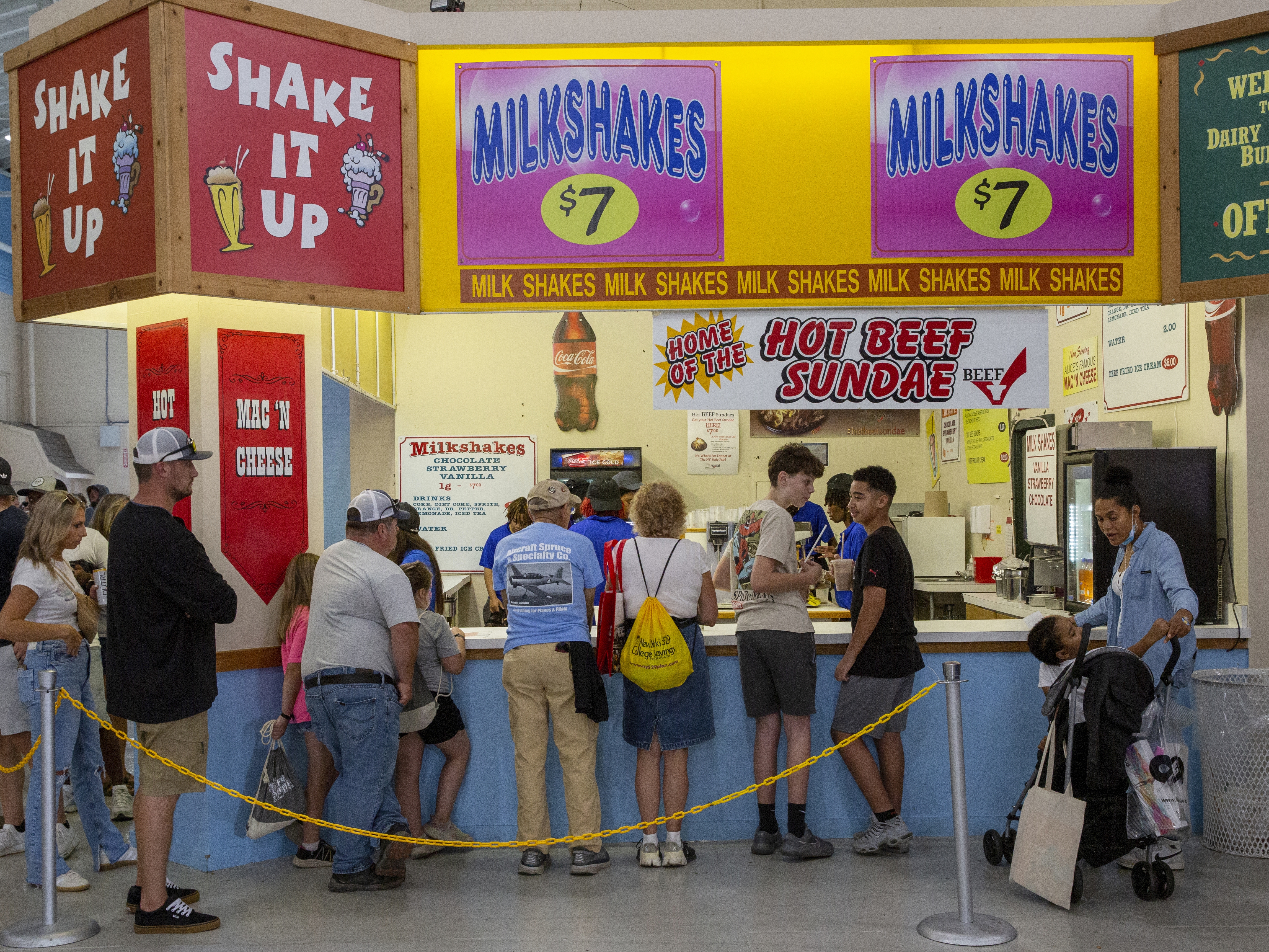 caption: A food counter menu lists various milkshakes and a Hot Beef Sundae for sale at the New York State Fair in Syracuse, New York, on Friday, August 30, 2024.